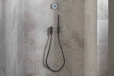 Photo of a mid-sized contemporary 3/4 wet room bathroom in Malmo with beige tile, marble, beige walls, marble floors, beige floor, an open shower and a shower seat.