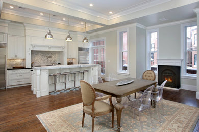 Elegant medium tone wood floor kitchen photo in Boston with an island, marble countertops, stone tile backsplash and stainless steel appliances