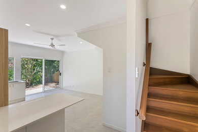 Photo of a small modern open concept living room in Brisbane with white walls and ceramic floors.