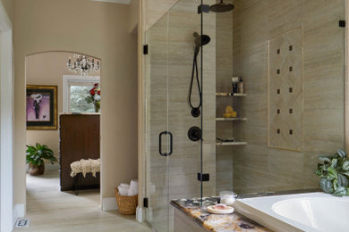 Example of a classic master porcelain tile tub/shower combo design in Denver with a hinged shower door