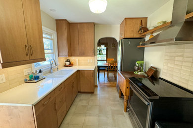 Inspiration for a mid-sized contemporary galley ceramic tile and beige floor kitchen pantry remodel in Other with an undermount sink, flat-panel cabinets, light wood cabinets, quartzite countertops, beige backsplash, ceramic backsplash, stainless steel appliances, no island and white countertops