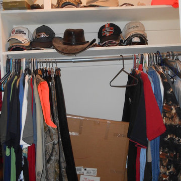 Before narrow walk-through closet with tee-shirt collection