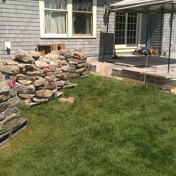 Blue stone patio and New England fieldstone capped sitting wall