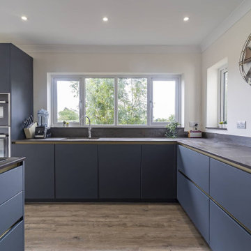 Modern Blue Kitchen with Mettalic Accents in Granborough