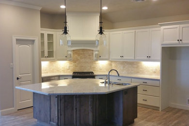 Eat-in kitchen - transitional ceramic tile eat-in kitchen idea in Austin with dark wood cabinets, granite countertops, an island and recessed-panel cabinets