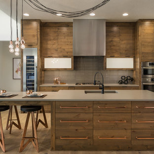Inspiration for a contemporary medium tone wood floor kitchen remodel in Boise with an undermount sink, flat-panel cabinets, medium tone wood cabinets, gray backsplash, stainless steel appliances and an island