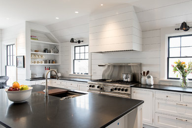 Open concept kitchen - large coastal l-shaped dark wood floor and brown floor open concept kitchen idea in Boston with an undermount sink, shaker cabinets, white cabinets, granite countertops, stainless steel appliances, an island, white backsplash and wood backsplash