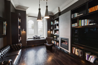 Design ideas for a medium sized contemporary enclosed games room in Melbourne with a reading nook, a standard fireplace, a stone fireplace surround, brown floors, grey walls, dark hardwood flooring and a built-in media unit.