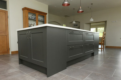 Inspiration for a large farmhouse single-wall kitchen/diner in Other with shaker cabinets, grey cabinets, composite countertops, an island and white worktops.