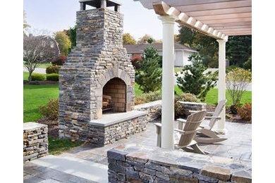 Example of a large tuscan backyard patio design in Providence with a fire pit