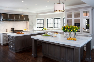 Large elegant l-shaped dark wood floor enclosed kitchen photo in DC Metro with an undermount sink, recessed-panel cabinets, gray cabinets, white backsplash, two islands, marble countertops, stainless steel appliances and stone slab backsplash