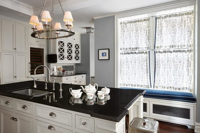 Enclosed kitchen - large contemporary l-shaped dark wood floor enclosed kitchen idea in New York with an undermount sink, recessed-panel cabinets, white cabinets, granite countertops, white backsplash, stone tile backsplash, stainless steel appliances and an island