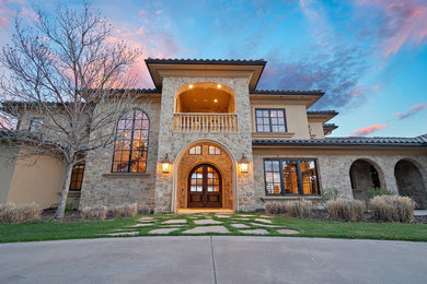 Inspiration for a huge mediterranean beige three-story mixed siding house exterior remodel in San Diego with a hip roof and a tile roof