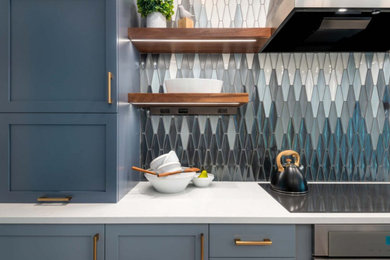 Transitional galley vinyl floor and gray floor kitchen photo in Other with an undermount sink, shaker cabinets, blue cabinets, quartz countertops, multicolored backsplash, ceramic backsplash, stainless steel appliances, a peninsula and white countertops