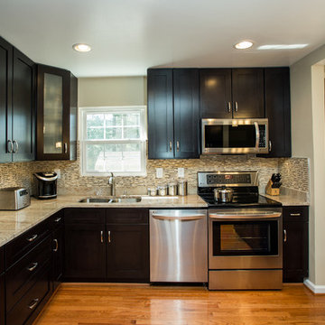 Espresso Kitchen Remodel with Granite Island and Stainless Steel Appliances