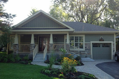 Inspiration for a mid-sized craftsman gray two-story mixed siding house exterior remodel in Other with a hip roof and a shingle roof