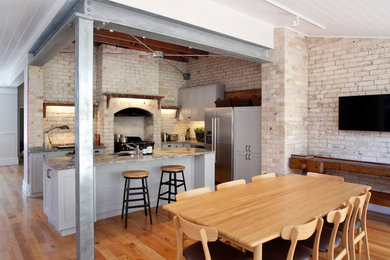 This is an example of an industrial kitchen/dining combo in Sydney.