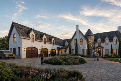 Large french country brown two-story brick and board and batten exterior home idea in Other with a shingle roof and a gray roof