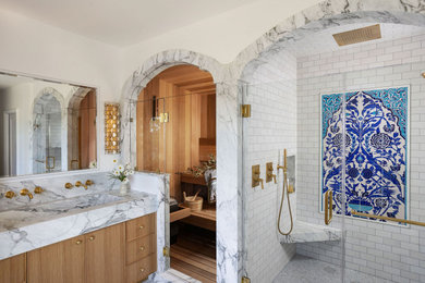 Inspiration for a large transitional master white tile and marble tile marble floor, white floor and double-sink bathroom remodel in San Francisco with white walls, a trough sink, marble countertops, a hinged shower door, a built-in vanity, flat-panel cabinets, medium tone wood cabinets and gray countertops