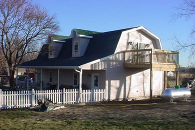 Mid-sized traditional beige two-story wood exterior home idea in Indianapolis with a clipped gable roof