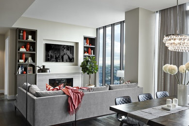 Living room - mid-sized contemporary open concept dark wood floor and brown floor living room idea in Nashville with gray walls, a standard fireplace, a stone fireplace and a wall-mounted tv