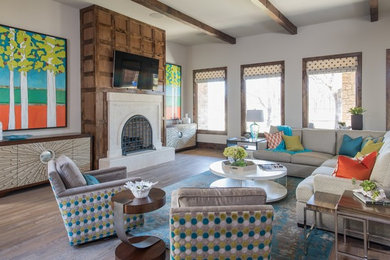 Inspiration for a large contemporary formal and open concept light wood floor and gray floor living room remodel in Dallas with beige walls, a standard fireplace, a wood fireplace surround and no tv
