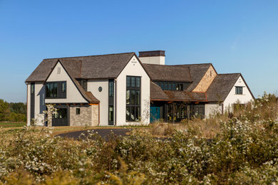 Inspiration for a large transitional three-story exterior home remodel in Minneapolis with a shingle roof and a brown roof