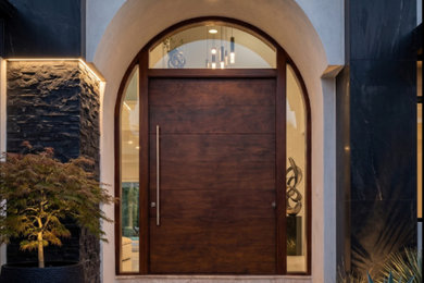 Entryway - large contemporary entryway idea in Miami with a dark wood front door