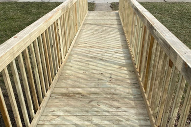 Inspiration for a timeless ground level wood railing deck remodel in Detroit
