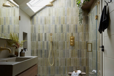 Inspiration for a large contemporary shower room bathroom in London with open cabinets, dark wood cabinets, a walk-in shower, a wall mounted toilet, green tiles, ceramic tiles, grey walls, concrete flooring, a wall-mounted sink, concrete worktops, grey floors, a hinged door, grey worktops, a feature wall, a single sink and a floating vanity unit.