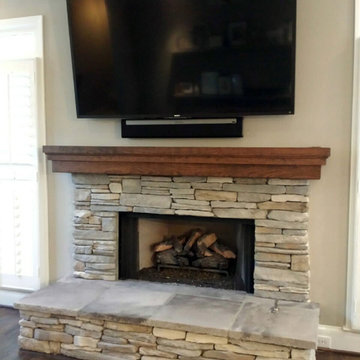 Stone Surrounded Fireplace with Cherry Mantle Beam