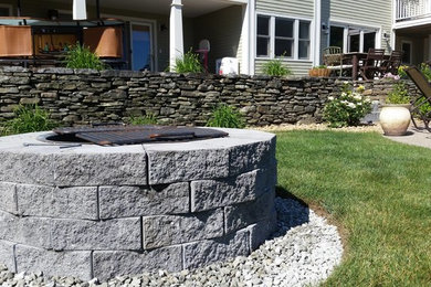 Photo of a mid-sized transitional partial sun backyard brick landscaping in Boston.