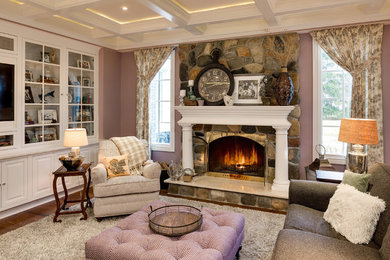 Large transitional living room in Detroit with pink walls, dark hardwood floors, a standard fireplace, a stone fireplace surround and brown floor.