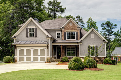 Example of a mid-sized arts and crafts gray two-story mixed siding house exterior design in Atlanta with a hip roof and a shingle roof