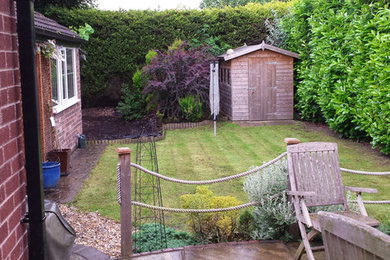 Design ideas for a mid-sized traditional backyard garden in Cheshire with decking.