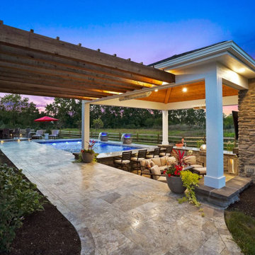 Pavilion with outdoor kitchen, gas fireplace and swim up bar.