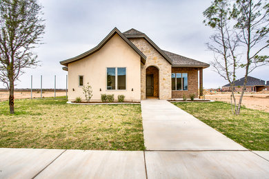 Small traditional beige one-story mixed siding house exterior idea in Other with a shingle roof