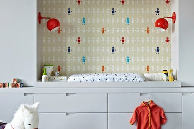 Nursery - mid-sized modern gender-neutral dark wood floor nursery idea in New York with beige walls