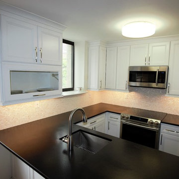 Flip up door extends over island for every day quick-use. Glass door provides si