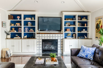 Living room - contemporary medium tone wood floor and brown floor living room idea in New York with gray walls, a standard fireplace, a tile fireplace and a wall-mounted tv