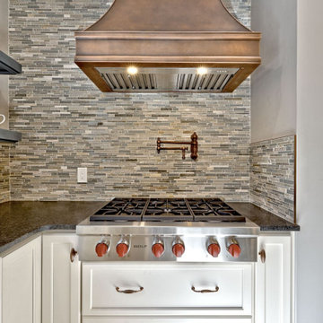 White Kitchen Remodel with Blue Island and Copper Accents