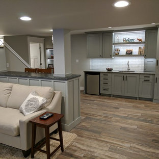 Medium sized classic look-out basement in Other with grey walls and porcelain flooring.