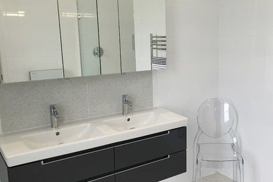 Design ideas for a modern master bathroom in Essex with an open shower, a wall-mount toilet, white tile and porcelain tile.