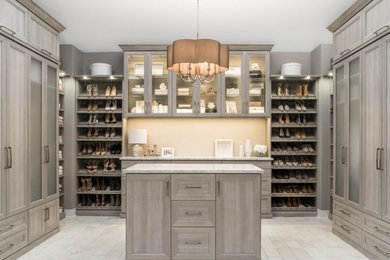 Inspiration for a large transitional walk-in wardrobe in Other with recessed-panel cabinets, grey cabinets and carpet.