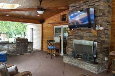 Patio - mid-sized modern backyard concrete patio idea in Nashville with a fire pit and a roof extension