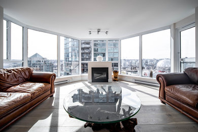 Living room - mid-sized modern formal gray floor living room idea in Vancouver with white walls, a standard fireplace, a plaster fireplace and no tv