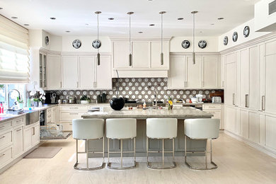 Inspiration for a large 1960s u-shaped light wood floor and multicolored floor kitchen pantry remodel in Orange County with a farmhouse sink, recessed-panel cabinets, white cabinets, granite countertops, multicolored backsplash, ceramic backsplash, paneled appliances, an island and multicolored countertops