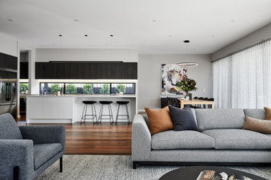 This is an example of an expansive open concept living room in Melbourne with medium hardwood floors.