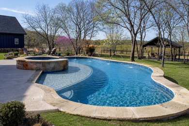 Inspiration for a large farmhouse backyard concrete and custom-shaped natural and privacy pool remodel in Dallas