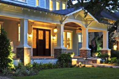 Inspiration for a large timeless brick front porch remodel in Tampa